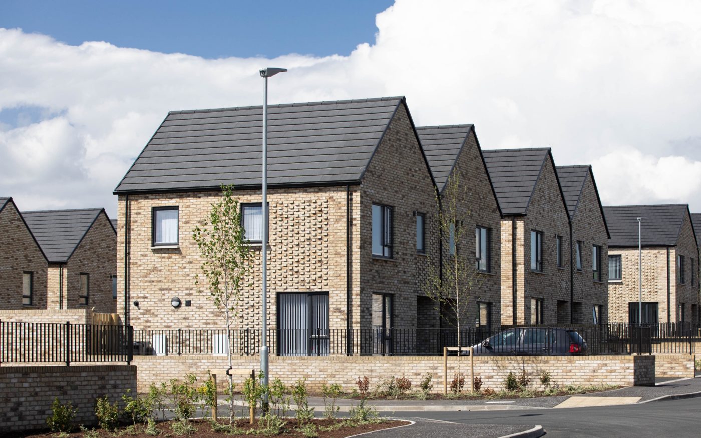 Multiple homes on new housing development with brick detail on the side of the building