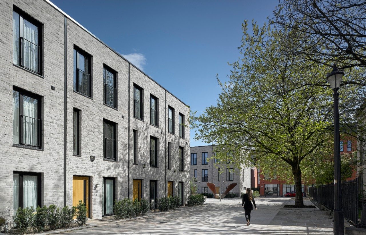 Modern residential building with trees and blue sky