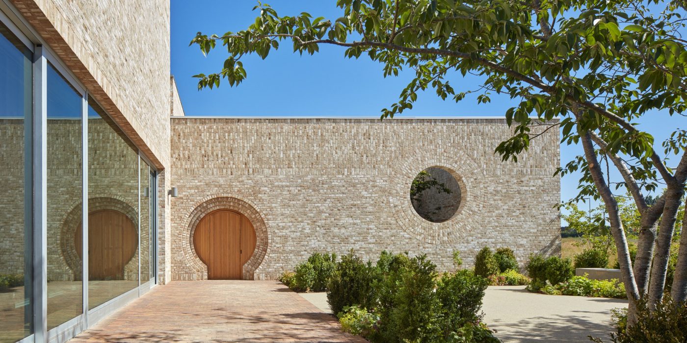 Modern brick building with circular door and window