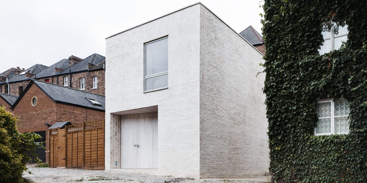 Modern white square building with single window