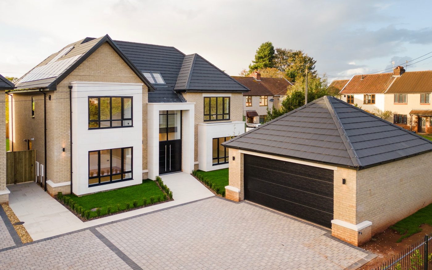 grand home with large driveway and garage