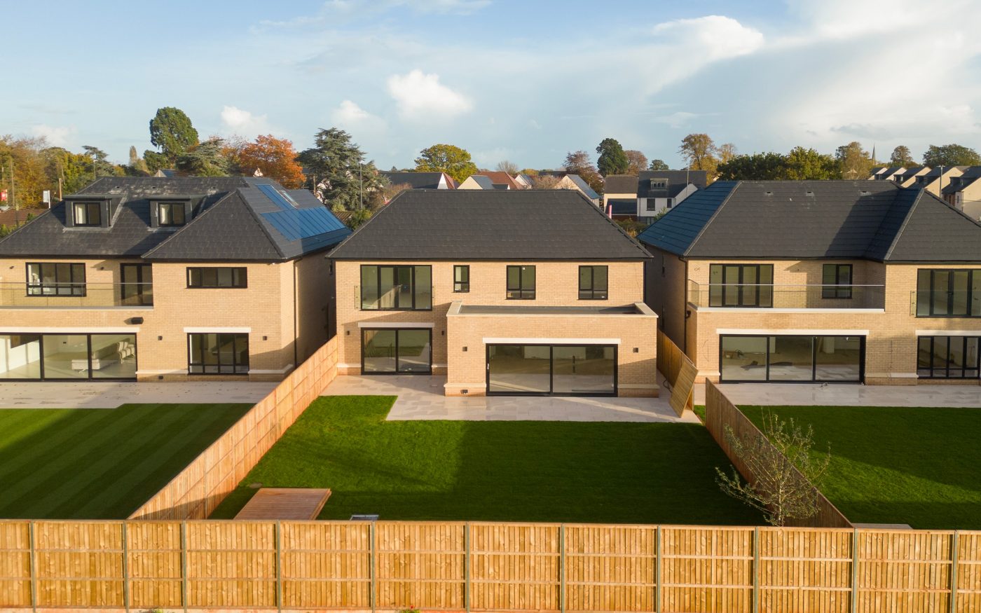 Back view of the gardens of multiple large homes