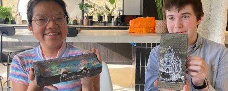 Woman painting a brick with yellow paint