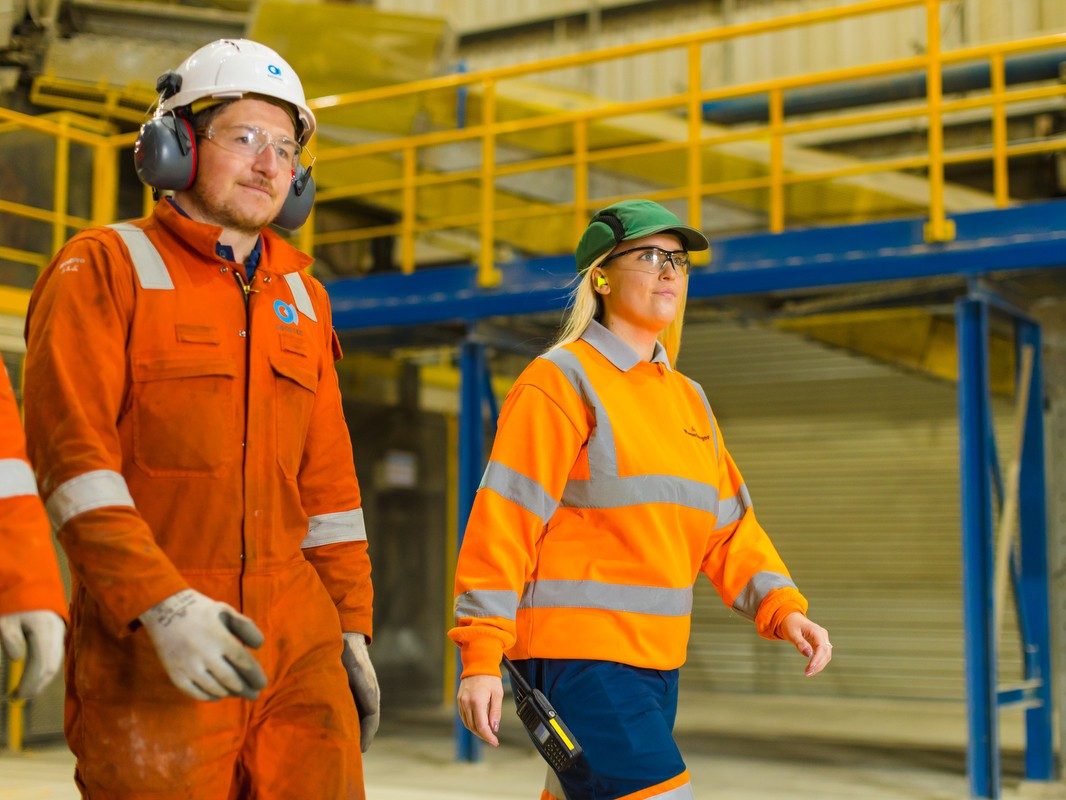 Man and woman walking through factory
