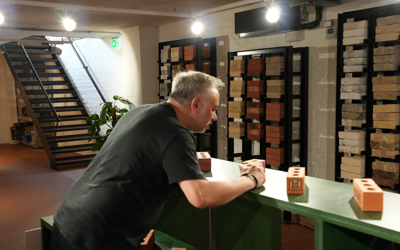 Kevin Singh judging a brick entry for Draw on a Brick Competition