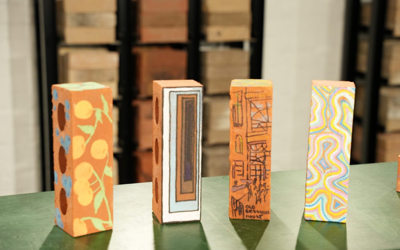 Four upright bricks with intricate designs on their sides