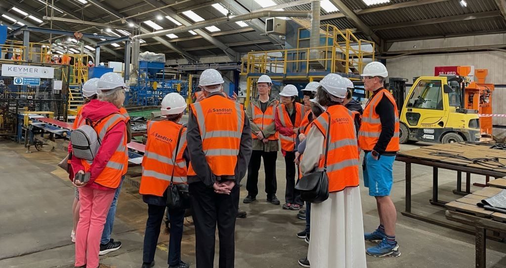 Group of people in his-vis jackets in Keymer's tile factory