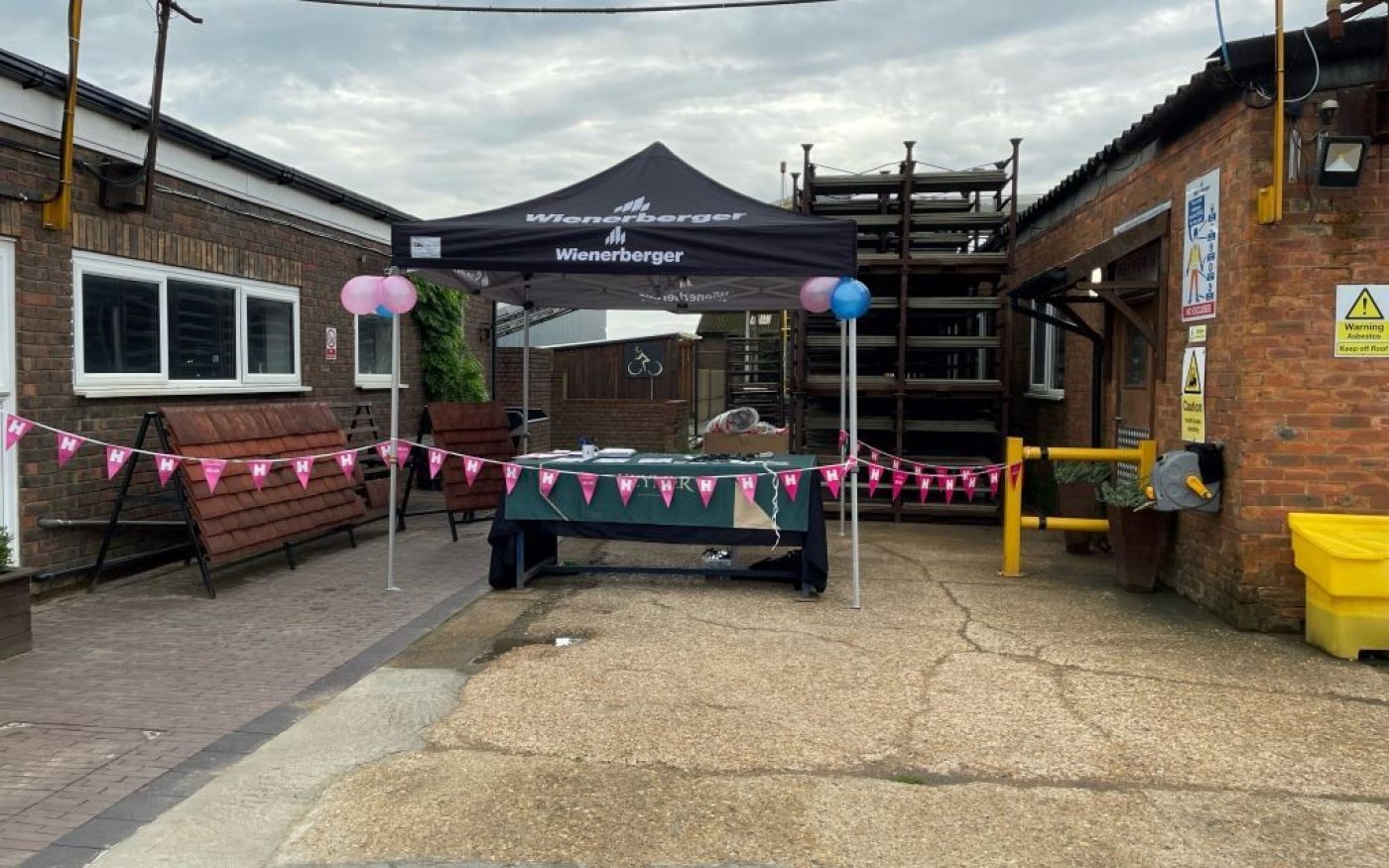 outdoor wienerbeger stand for event with pink bunting and ballons around it