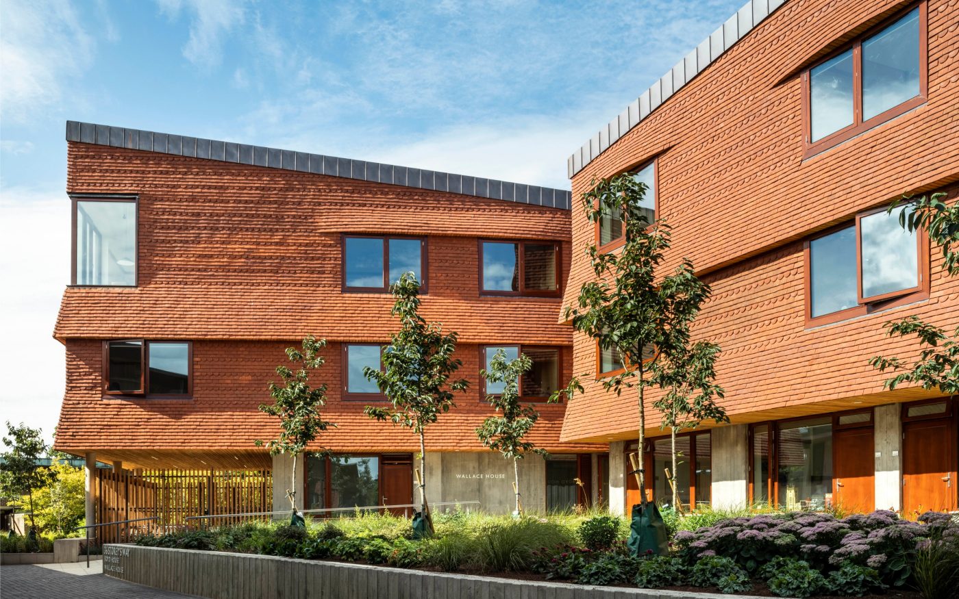 Modern development using red Keymer tiles for vertical tiling