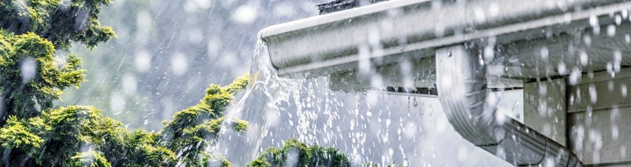 Roof guttering overflowing with rain water
