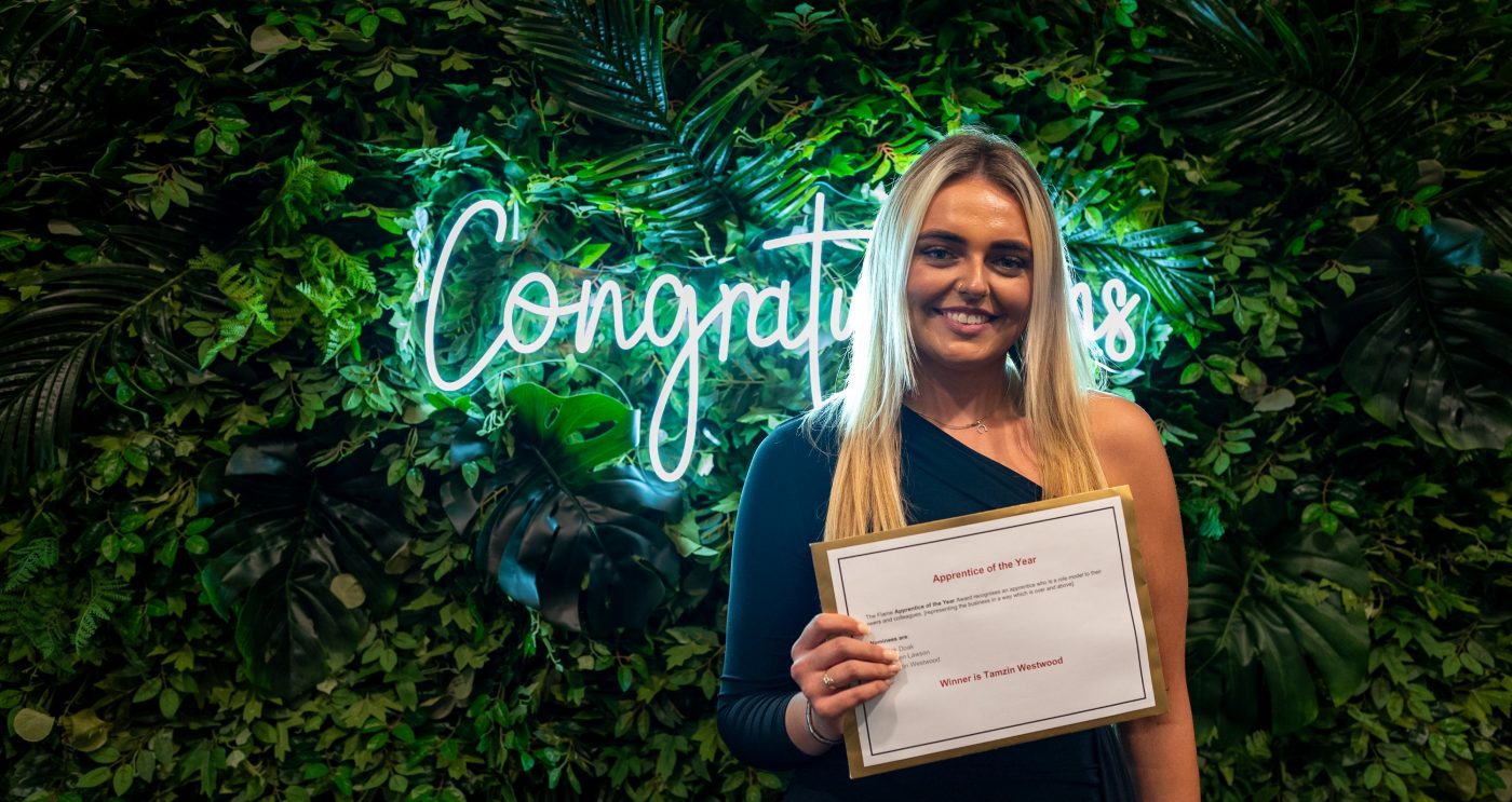 Tazmin with certificate in front of congratulations sign