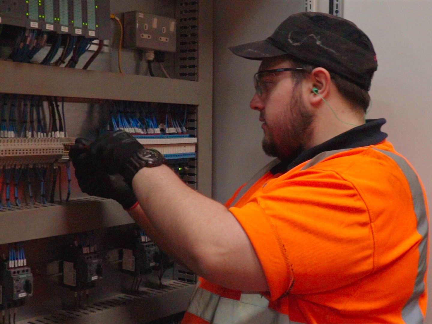 Apprentice in high visibility safety gear learning engineering skills at Wienerberger factory