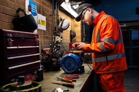 Apprentice Engineering working at a workshop desk
