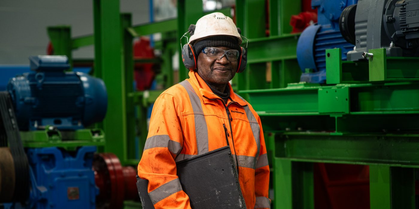 Man working at the Ewhurst Factory smiling towards the camera