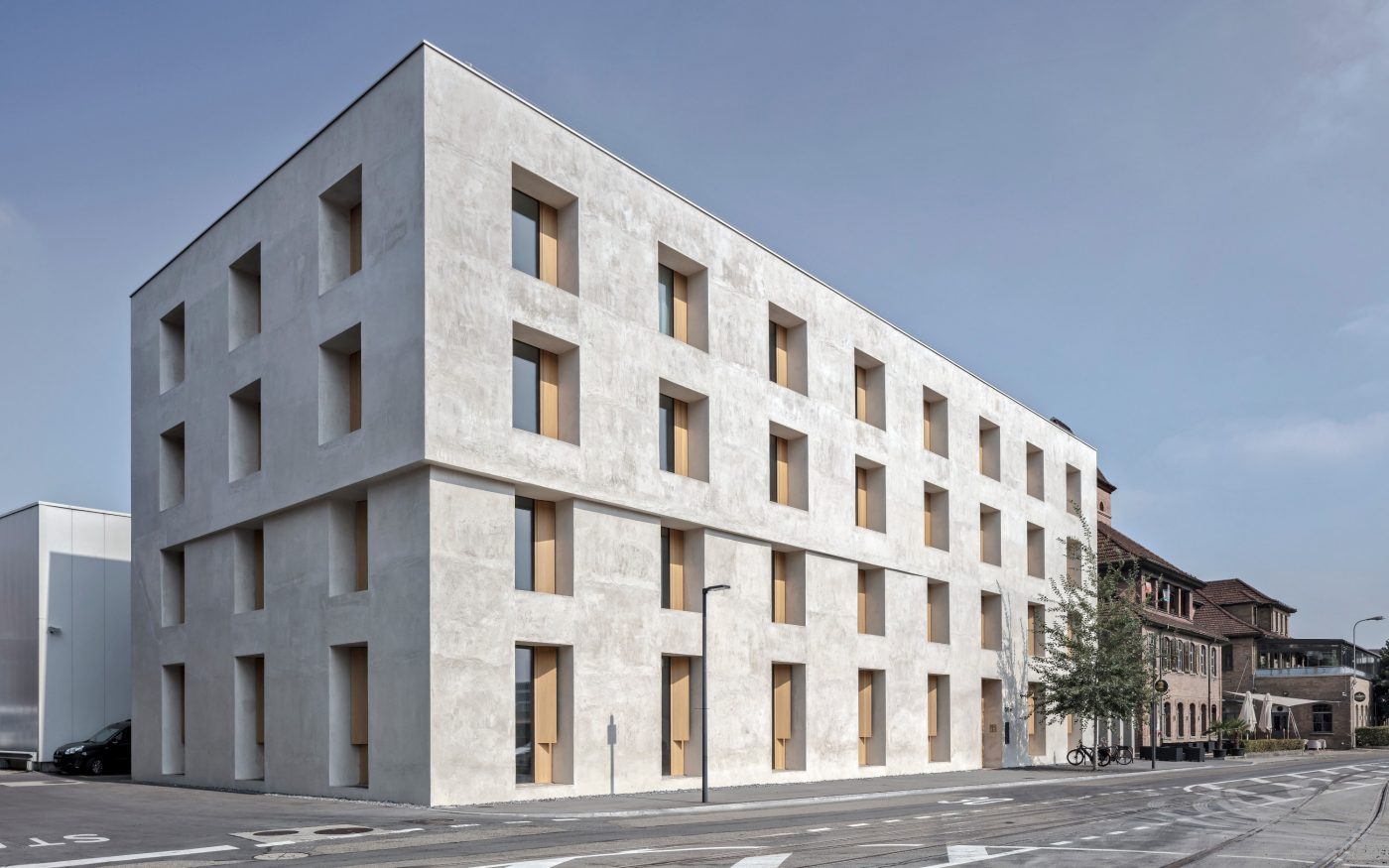 Sun shining on balconies of modern red brick apartment building