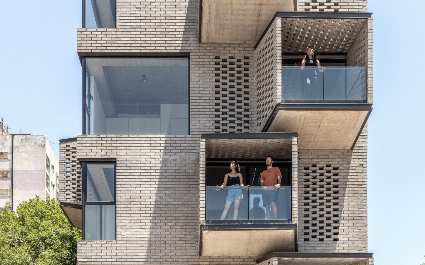 People on balconies of M 5605 apartment building