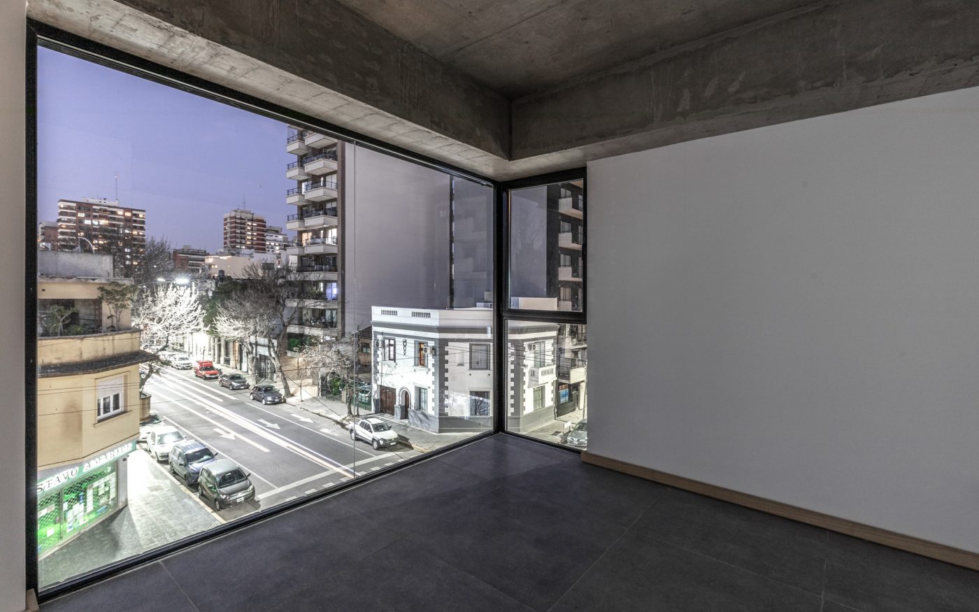 Interior of modern apartment building with large window looking onto street