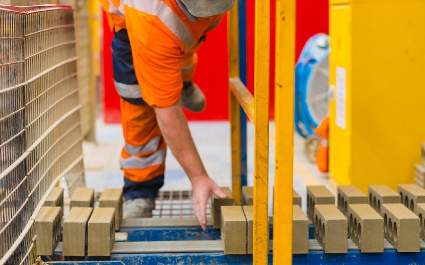 Man in Wienerberger factory on production line of bricks