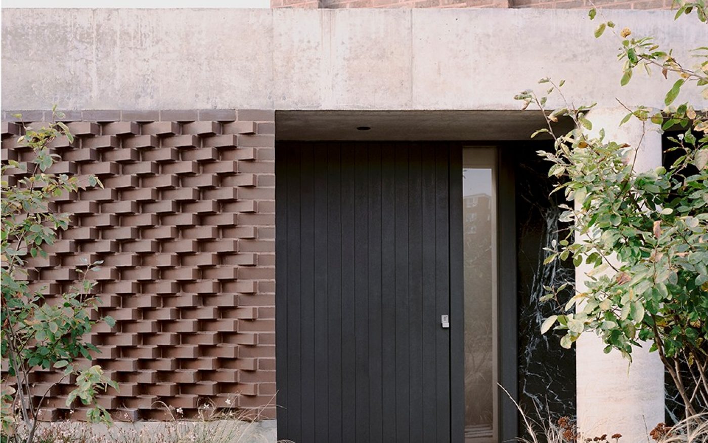Close up of front door and brick detail of the house