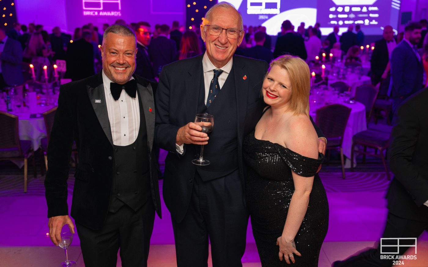 Smartly dressed attendees posing for picture