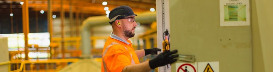 Man looking at techncial equipment in the factory