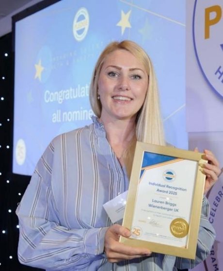 Lauren Briggs holding up her Pledge Award Certificate