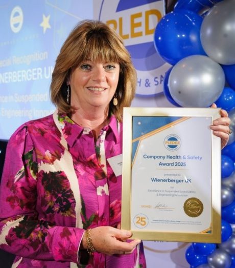 Karen Springett holding up her Pledge Award Certificate