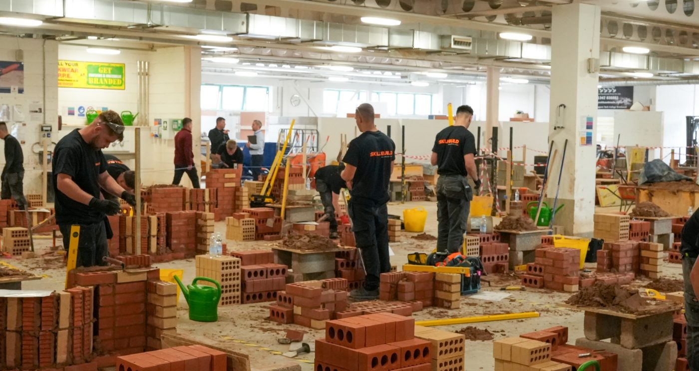 SkillBuild competitors at their stations building brick walls with skill and precision