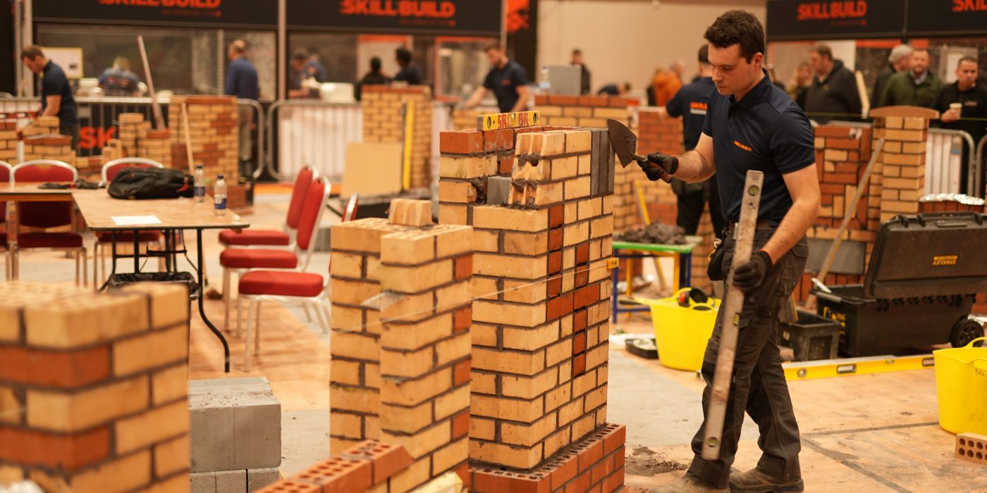 Man competing in a bricklaying competition
