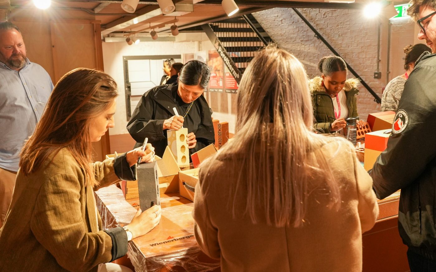 A group of people creatively drawing on bricks