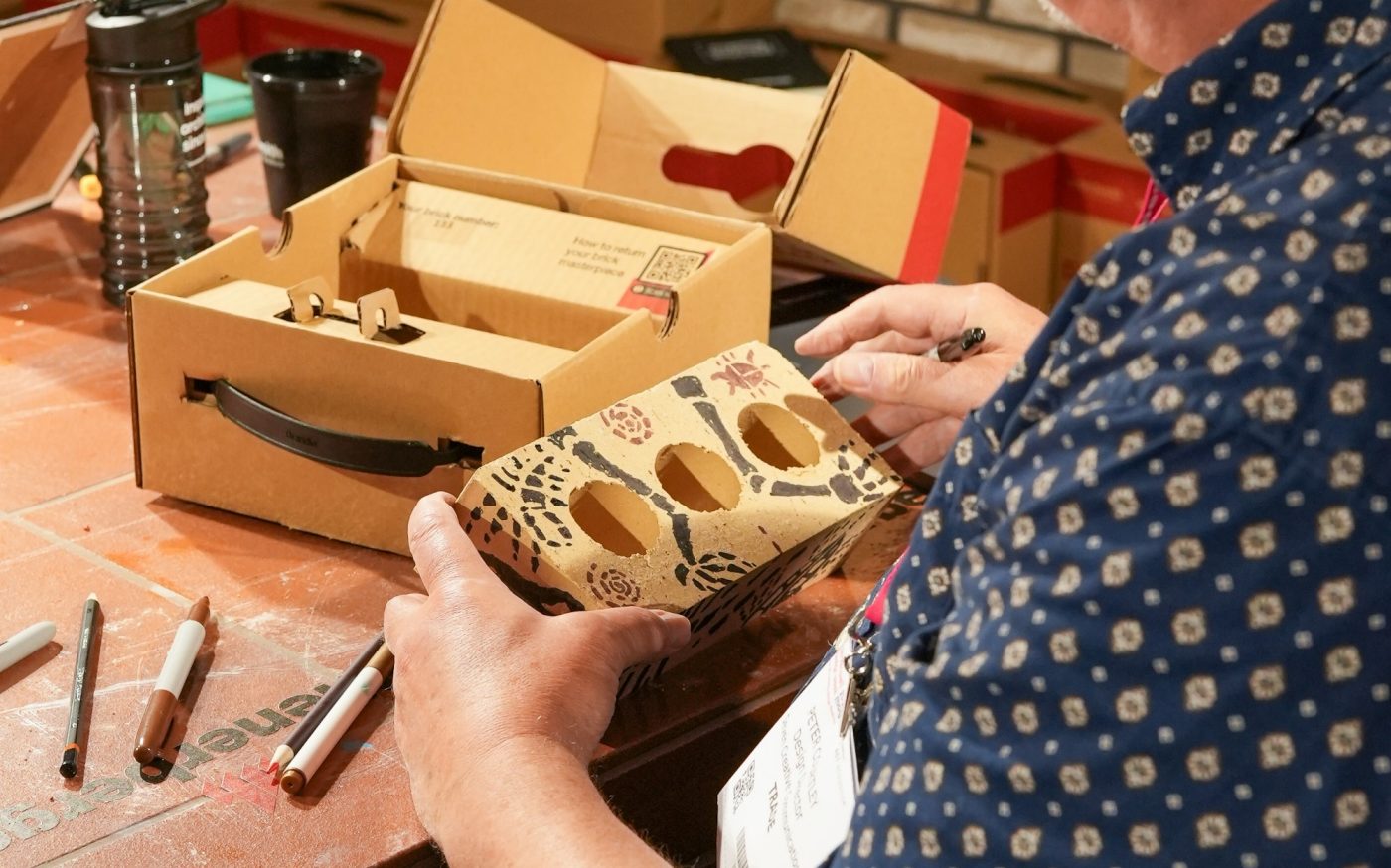 Skeleton arms drawn onto a brick