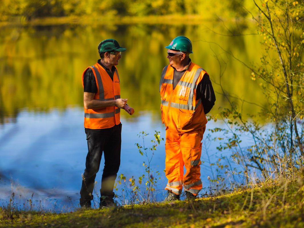 Two men stood at the edge of Ewhurst quarry lake