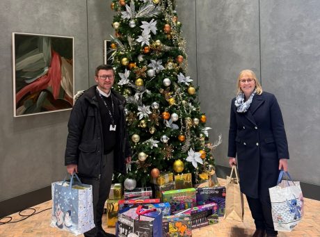 2 building product design colleagues donating gifts to local charities