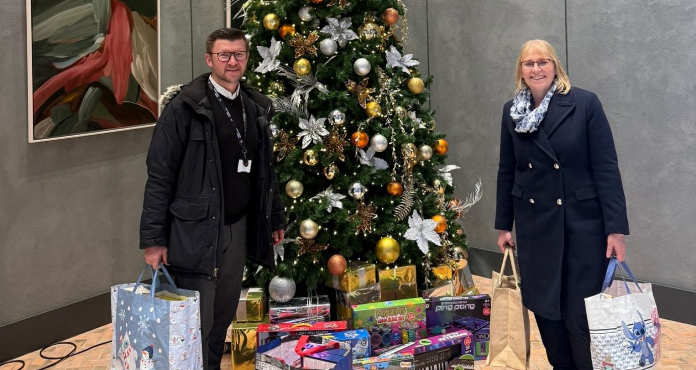 BPD colleagues stood next to a christmas tree delivering presents