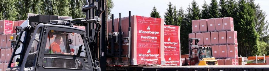 Forklift truck transporting pallet of Wienerberger Porotherm blocks