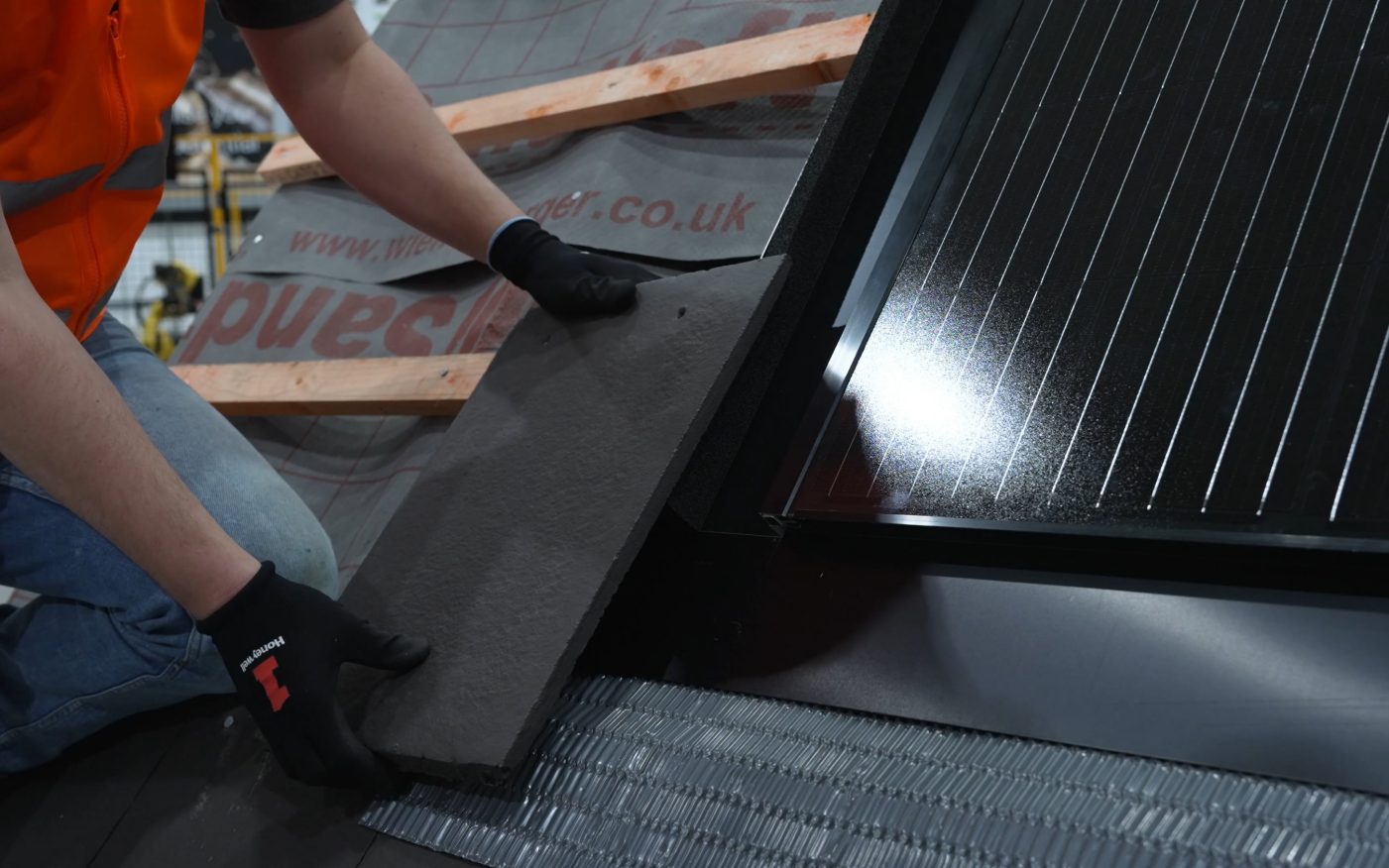 Roofer installing in-roof solar