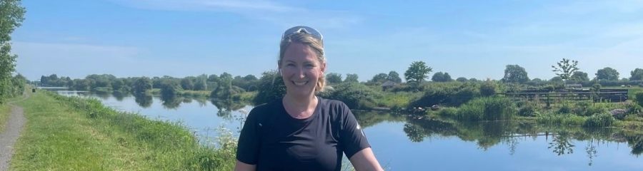 Head of sales, Emily Badger smiling with green scenery behind her