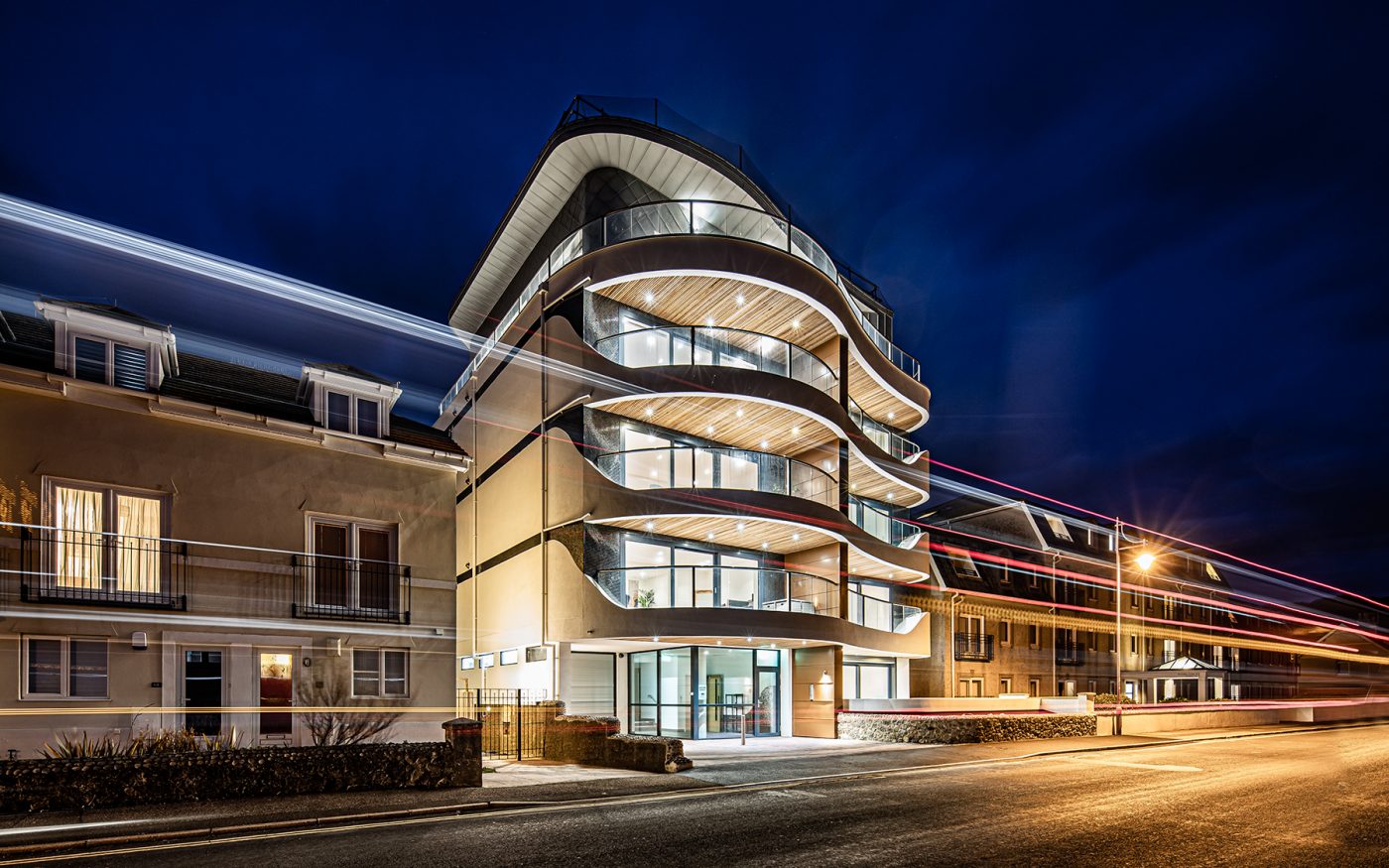 Modern apartment building lit up at night