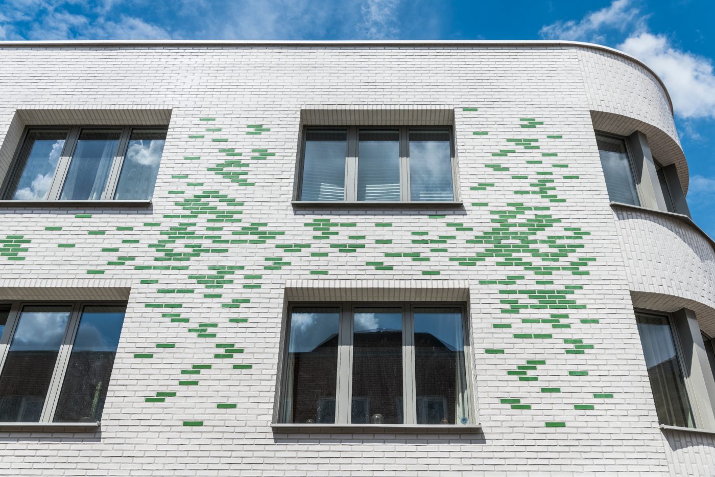 White and green glazed brick building
