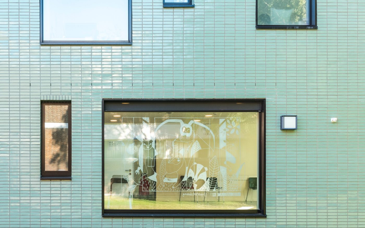 Pale green glazed brick in stack bond on a healthcare facility