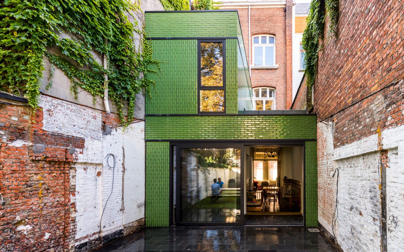 Terraced house extension in green glazed brick