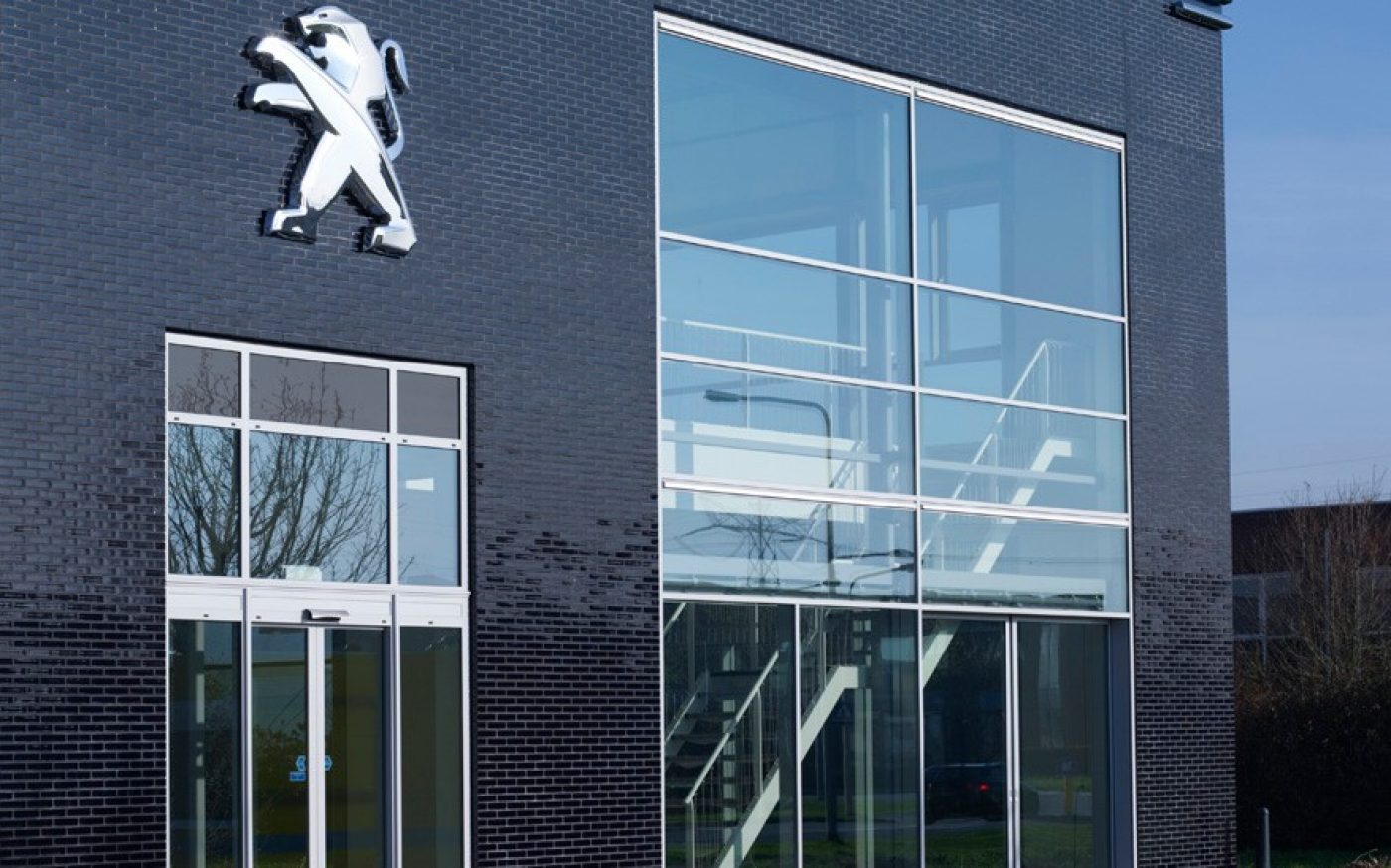 Navy blue glazed bricks on Peugeot garage building