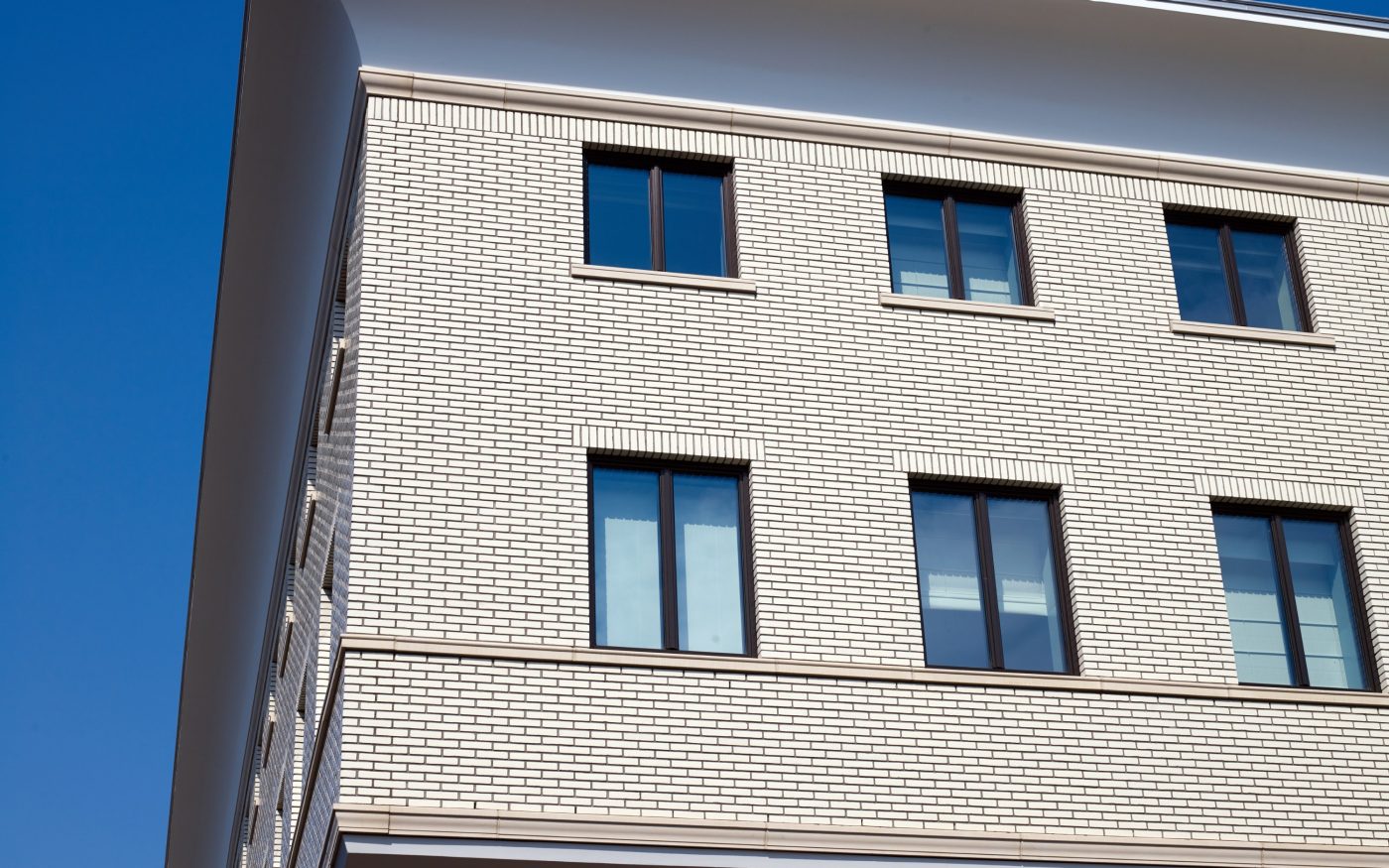 Multi storey building with white glazed brick facade