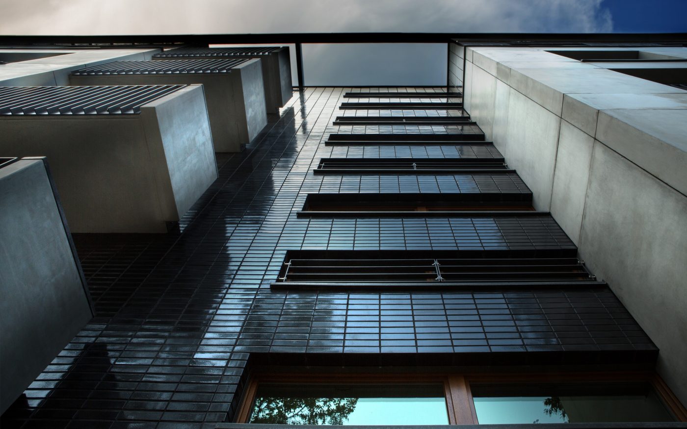 Modern high rise building with black glazed brick facade