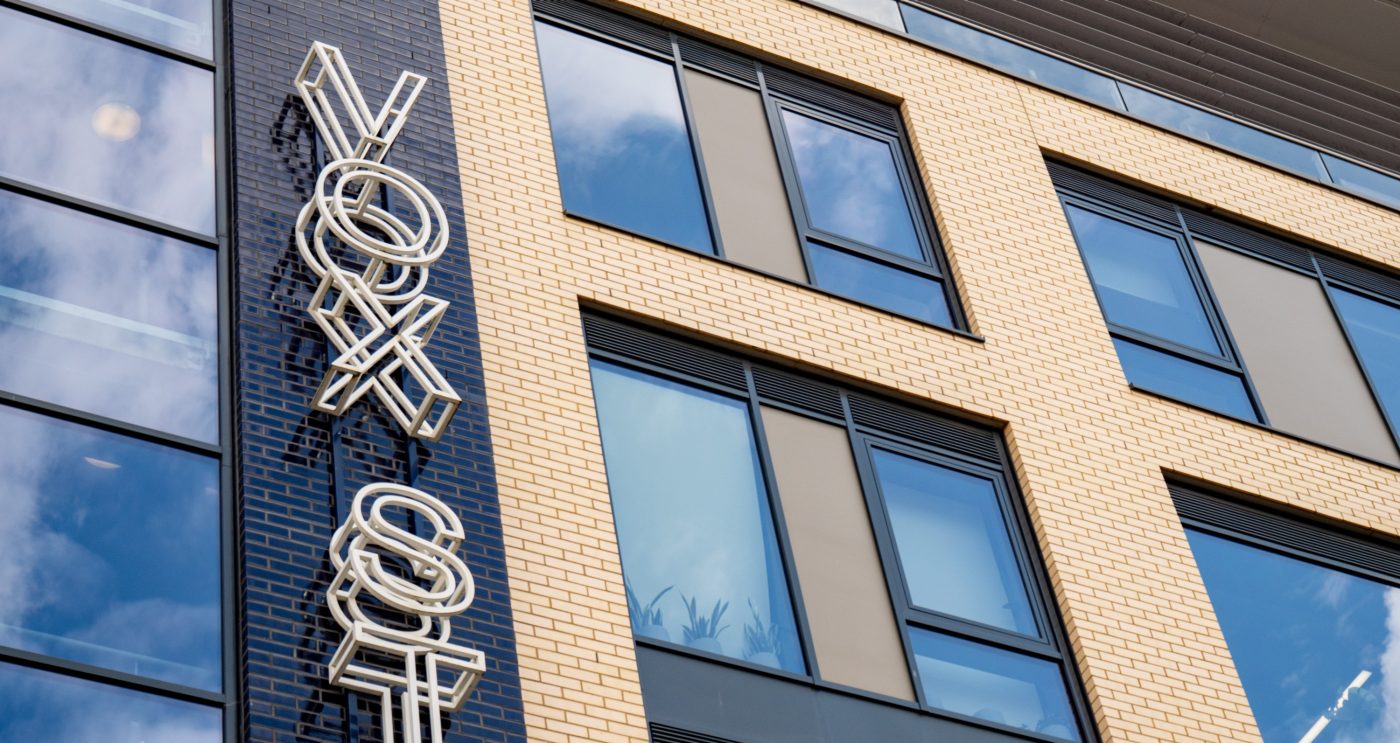 Modern building with brick tile facade and Vox Studios sign