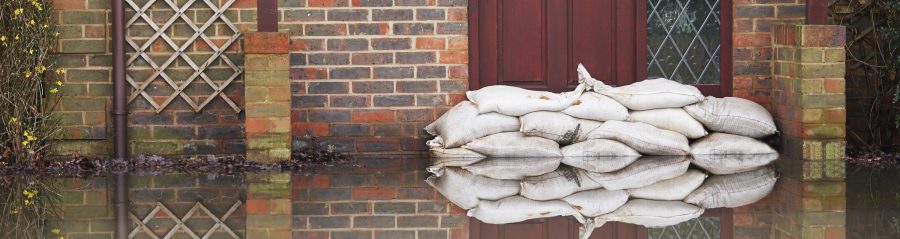Sandbags Outside Front Door Of Flooded House