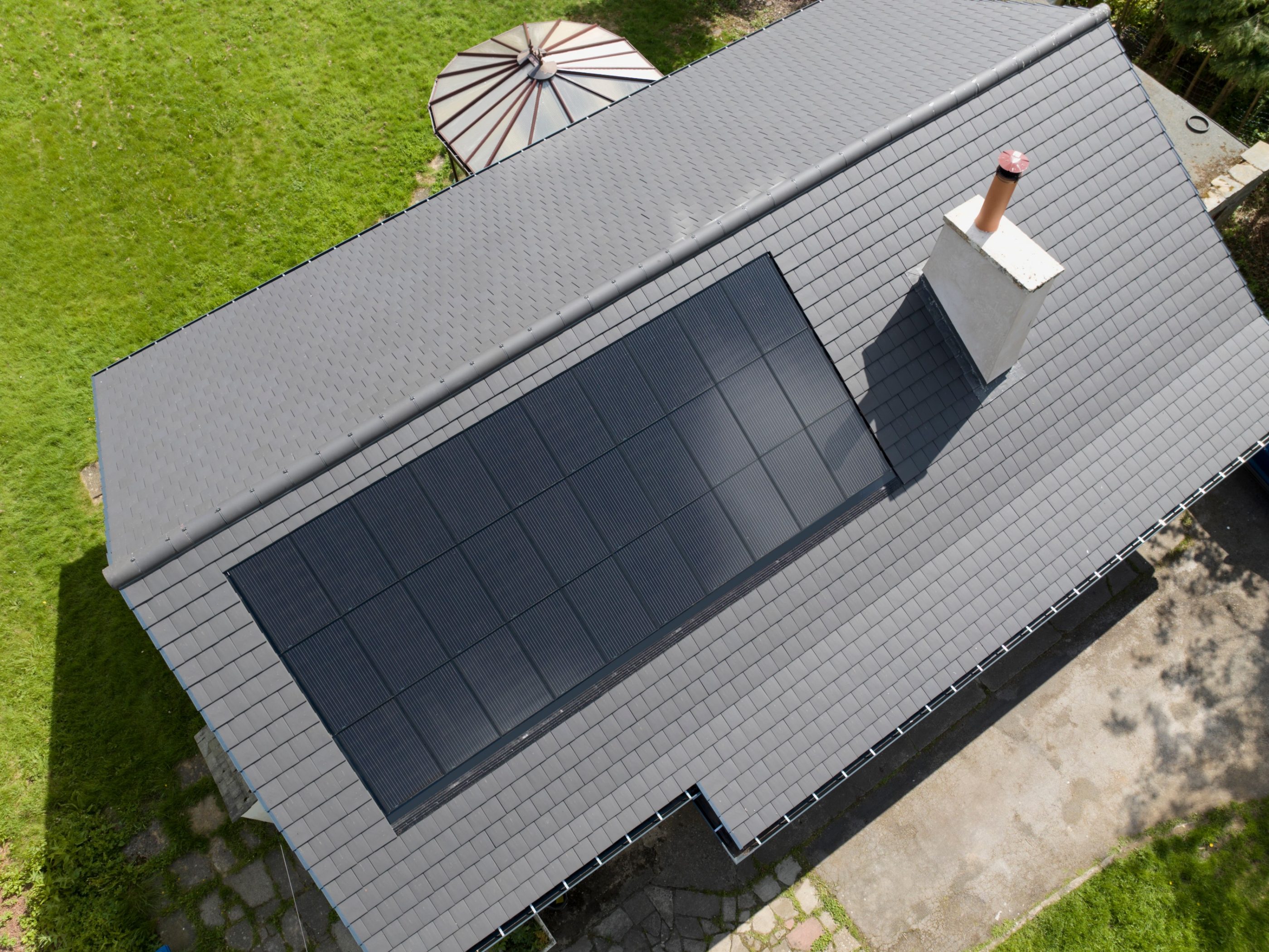 Birds eye view of a grey roof with solar panels installed