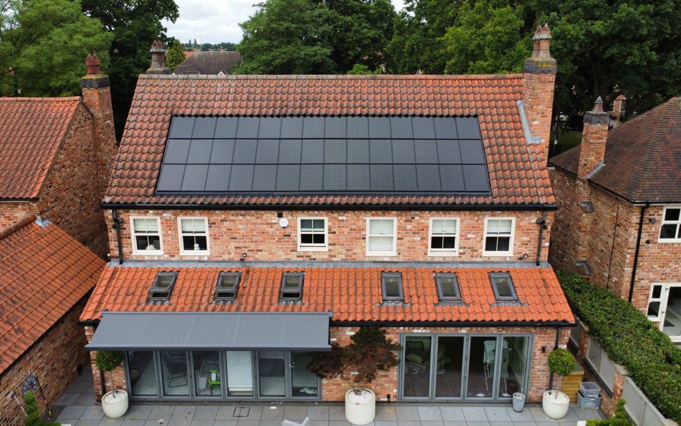 large home with with terracotta roof tiles and in-roof solar panels