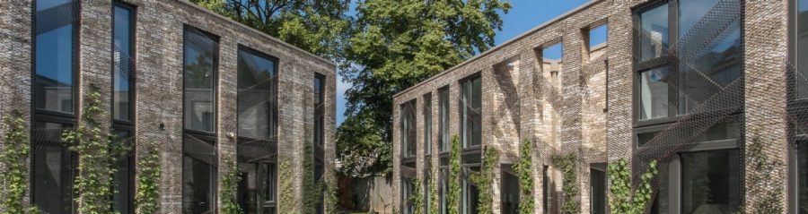 Hyper modern brick residential buildings with grass and paved area