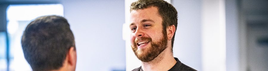 Tom Rogerson chatting to someone in the office